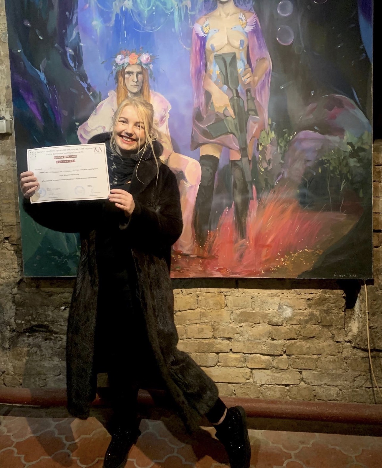 Marina Stognieva receiving her diploma from the School of Curators at the Ra Art Gallery in Kyiv on 23 February 2022